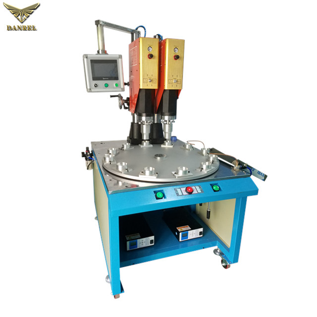 China High Speed Plastic Sonic Welder, Rotary Table Ultrasonic PP Pacifier Welding Machine with Unloader and Film Feeder