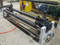 Waste edge slitting device for extrusion laminating machine